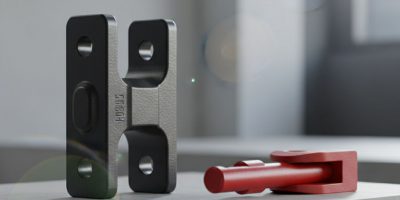 Close-up of a robust shipping container corner casting with a twist lock engaged, showcasing the secure connection provided b